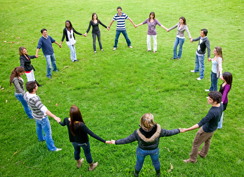 big friends doing a circle smiling and having fun in the park