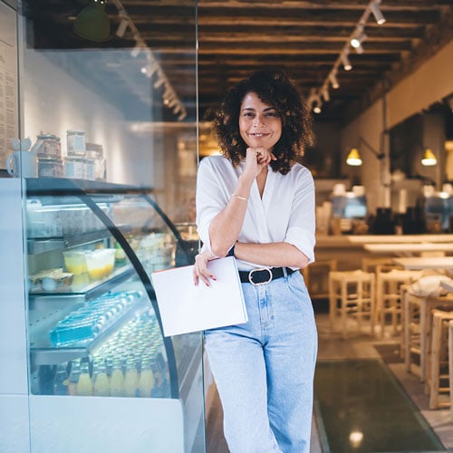 Woman franchise business owner standing in restaurant 