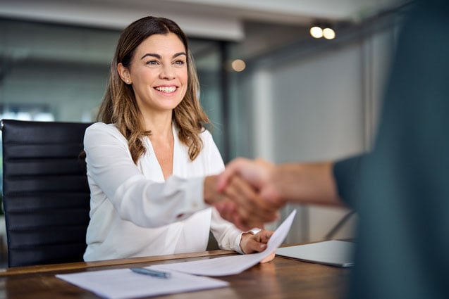Two people completing secure documents for business deal