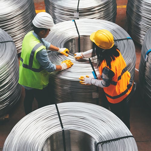 Two workers working in supply chain manufacturing 