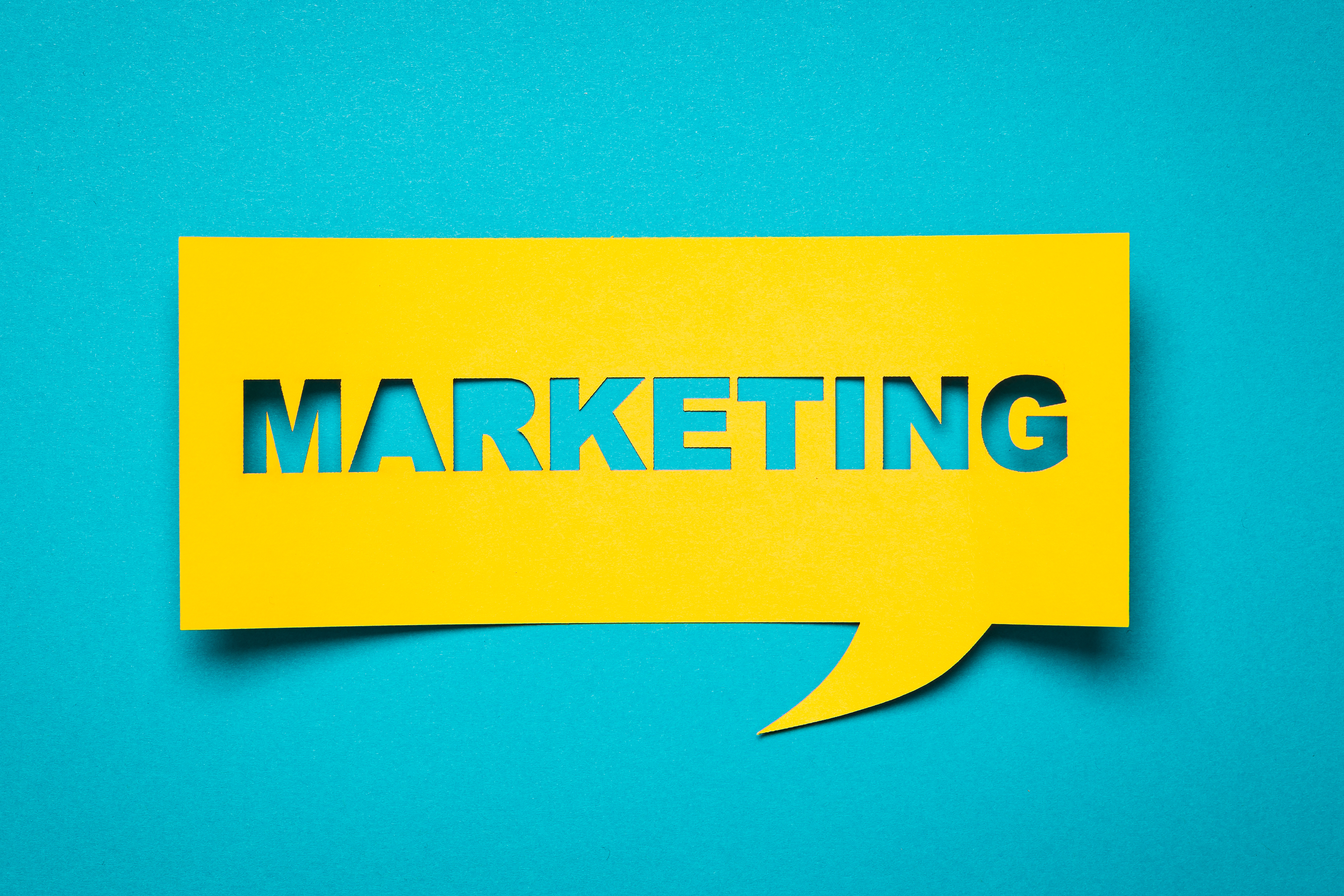 Yellow speech bubble with the word "marketing" inside 
