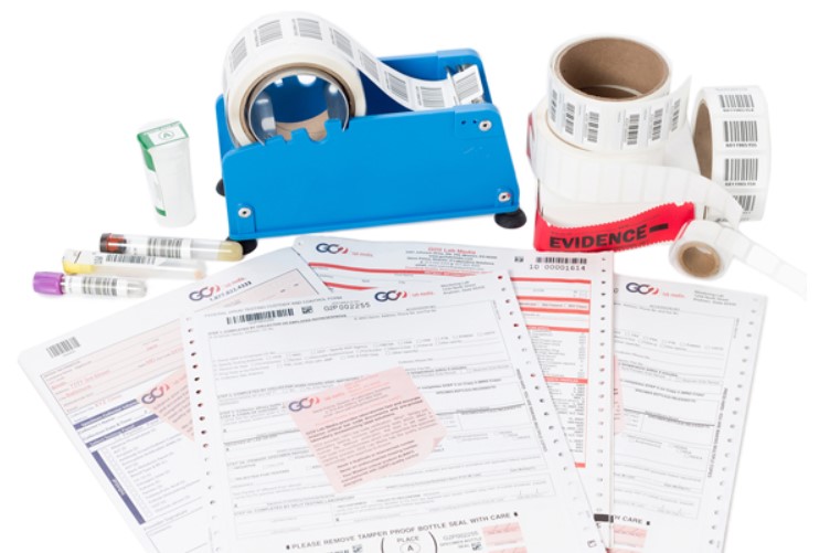 Print and printed materials for clinical laboratories are scattered on a white table.