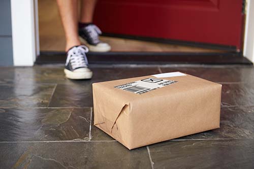 Ecommerce Packaging on doorstep of house after being delivered to consumer